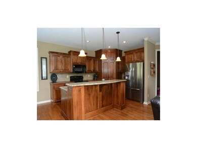 Big kitchen island with granite counters.