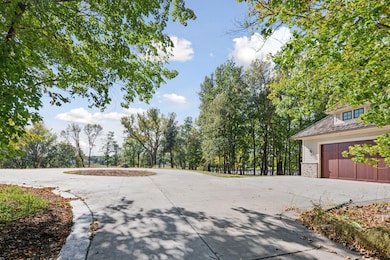 Auto-court and detached garage upon entry.