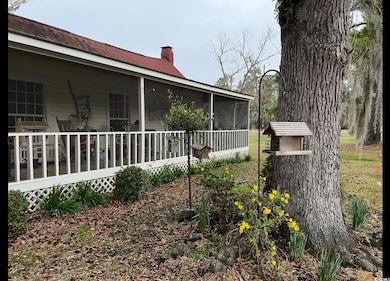 View of home's exterior featuring a chimney and a sunroom