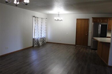 Unfurnished dining area featuring a chandelier and