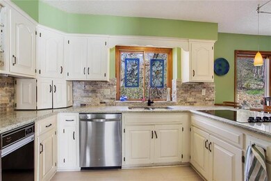 White cabinets. Stainless dishwasher.