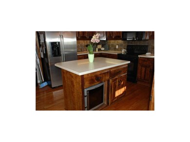 Kitchen isle with built in wine refrigerator.