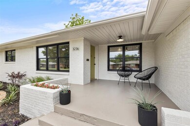 Property entrance with covered porch and brick siding