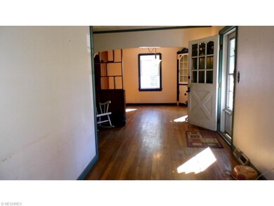 Enter through front door into living area with har