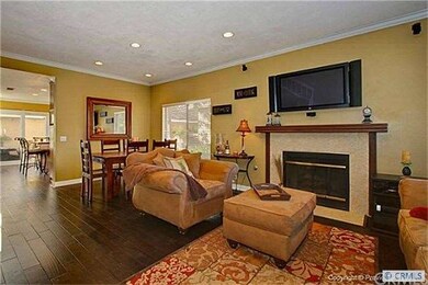 Living room features flat screen TV mounted above 