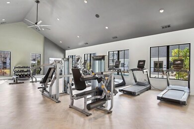 Exercise room with high vaulted ceiling and ceilin