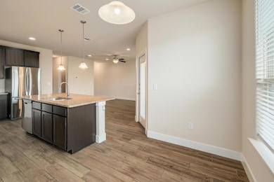 Kitchen with recessed lighting, visible vents, a 
