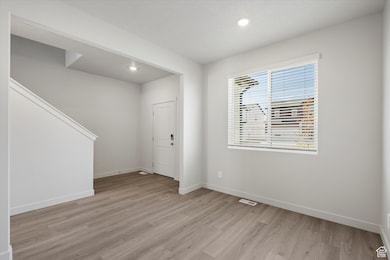 Entrance foyer featuring recessed lighting, light wood-style floors, and stairs