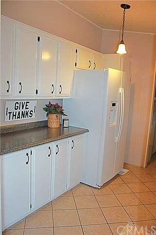 The other side of the kitchen with storage and mor