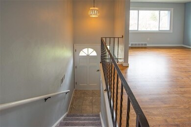 Bright tiled and new carpeting and gleaming refini