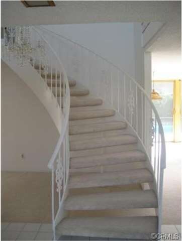 Entrance foyer with curved staircase.