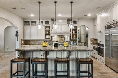 A bright and inviting kitchen with an impressive island that serves as the centerpiece for ease of entertaining.