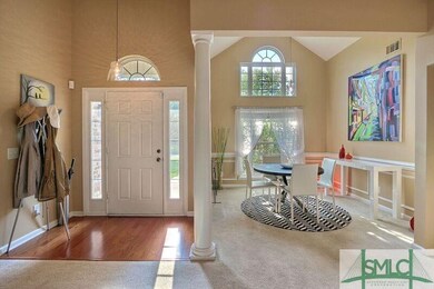 Light filled entry way and formal dining room with