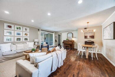 Spacious living room with great natural light, decorative lighting, recessed lighting, hardwood floors, crown molding and baseboards.