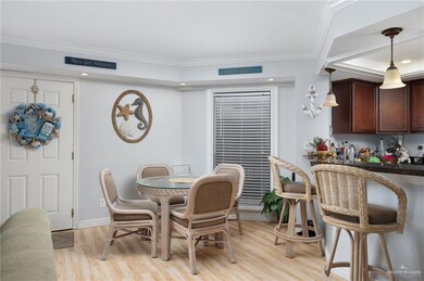 Dining area with crown molding, light hardwood / wood-style flooring, and sink