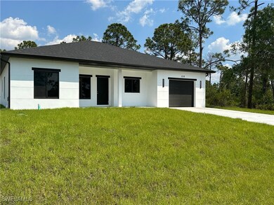 View of front of house with a garage, stucco sidin