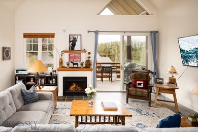 Tiled living room with high vaulted ceiling