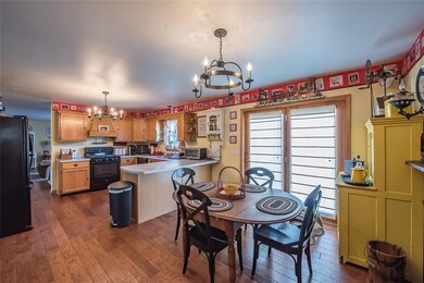 This eat in kitchen features oak cabinetry, a rang