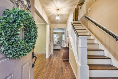 Rich luxury vinyl floors and piano key staircase greet you as you walk through the door.