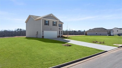 View of front of home with a garage, driveway, a f