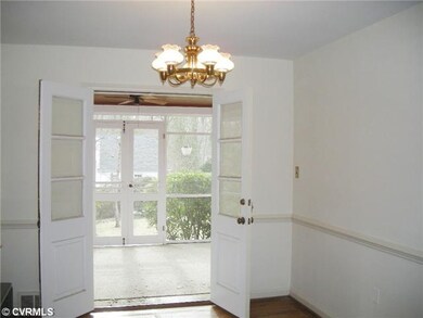 Dining Room - Dining room view of sunroom through 