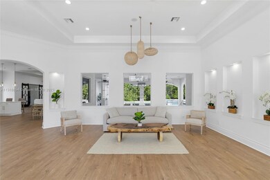 As you open doors into the welcoming living room, you have a postcard-perfect view of your private backyard oasis enveloped by a gorgeous bamboo wall.