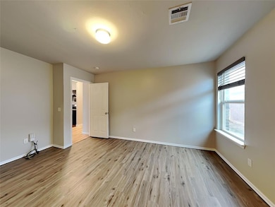 Empty room featuring wood finished floors and baseboards