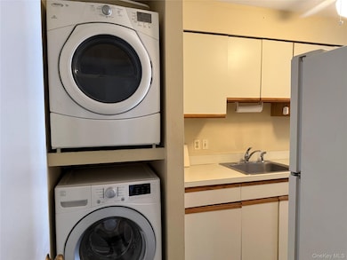 Laundry area featuring stacked washer and clothes dryer
