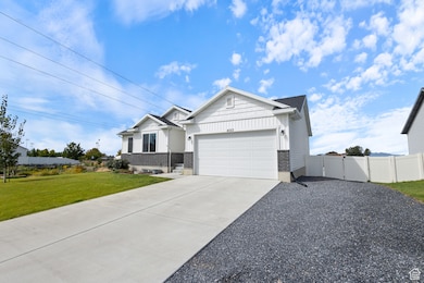 View of front of house with board and batten siding, concrete driveway, and an attached garage