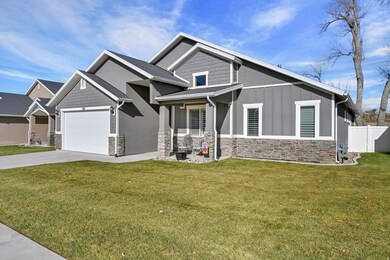Craftsman house featuring stone siding, concrete driveway, board and batten siding, and an attached garage