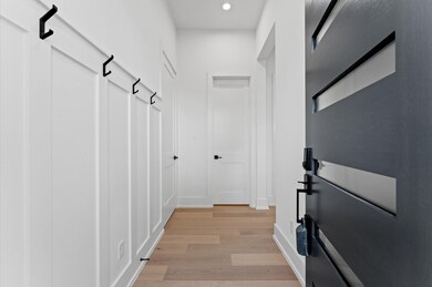 Entry way leads to mud room and powder room.