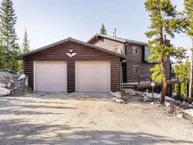 View of front facade featuring a wooden deck and a