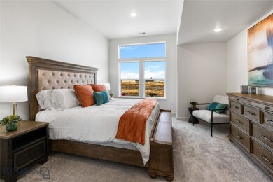 Bedroom with vaulted ceiling and light carpet
