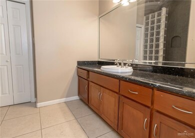 Bathroom with tile patterned flooring and vanity