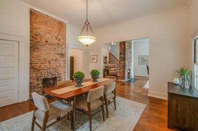 Formal dining room with exposed brick