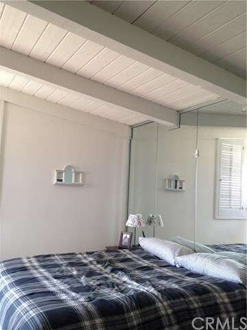 The master bedroom has beamed ceiling.