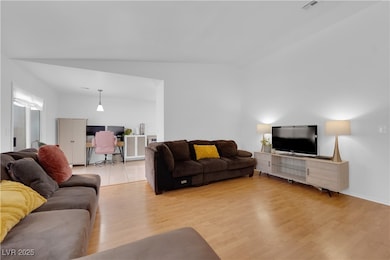 Living room with a desk and light wood-style floor