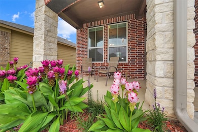 Charming front porch with brick and stone accents,