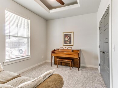 Living area featuring light colored carpet, a tray