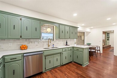 Kitchen featuring a peninsula, a sink, light count