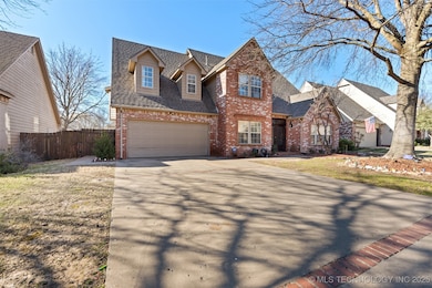 Traditional-style house with brick siding, fence,