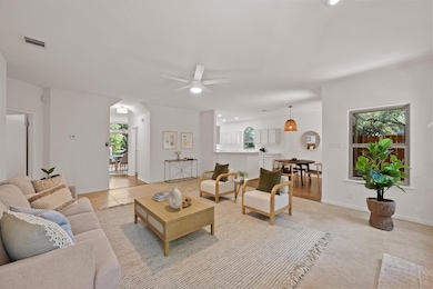 Living area with light tile patterned floors, a c