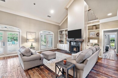 Living room featuring high vaulted ceiling, dark h