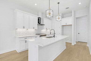 Kitchen furnished with stove, microwave, and dishwasher