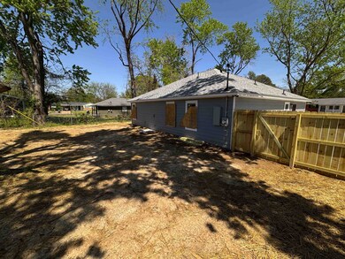 View of side of home featuring a gate