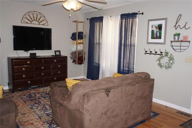 View of the living room. Note the wood flooring.