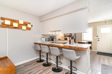 Kitchen with wood finished floors, baseboards, a k