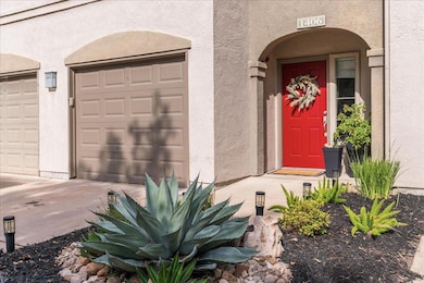 View of exterior entry featuring stucco siding and a garage