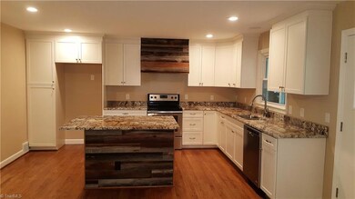 Beautiful kitchen with granite counter tops, stainless appliances, and an island.