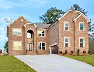 View of front of home with a front lawn and brick 